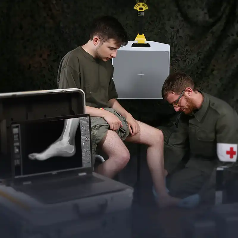 A doctor exams a wounded soldier